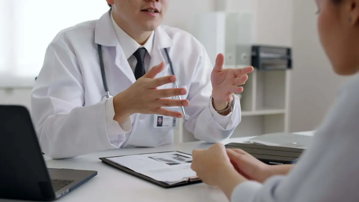Doctor discussing mental health treatment options with a patient during a medical consultation in a clinical office setting.