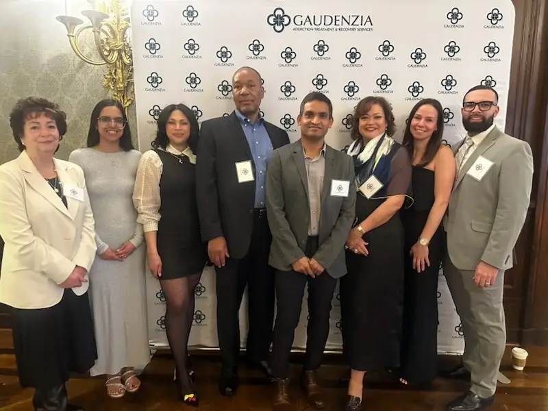 Omega Physicians group of smiling healthcare professionals, including doctors and nurses, staff members at Adversity to Hope: An Evening of Impact.